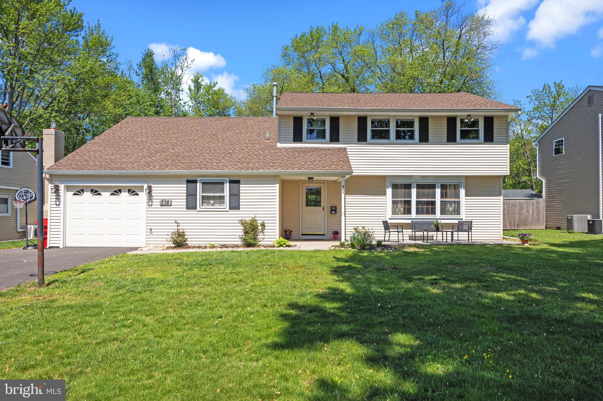 238 Centennial Road Warminster, PA 18974 - Photo 34 of 34 a front view of a house with a garden and trees