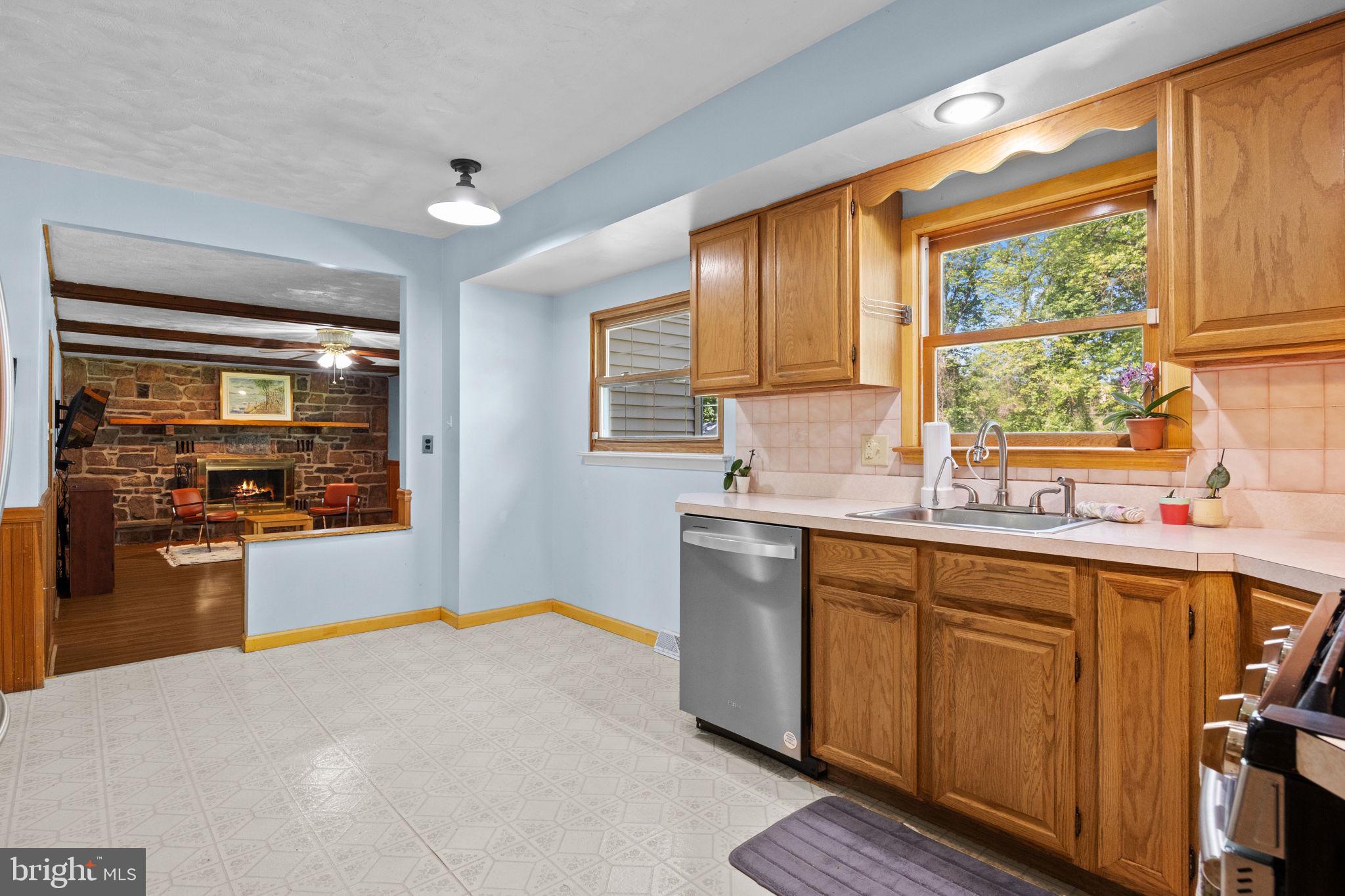 238 Centennial Road Warminster, PA 18974 - Photo 5 of 34 a kitchen with stainless steel appliances a sink cabinets and wooden floor