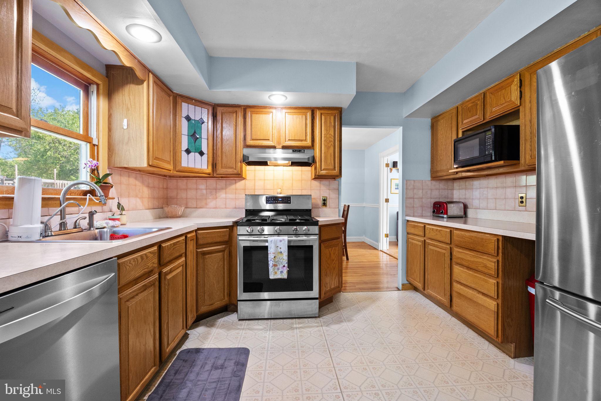 238 Centennial Road Warminster, PA 18974 - Photo 7 of 34 a kitchen with stainless steel appliances granite countertop a stove a sink and a microwave