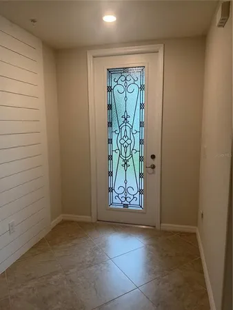 a view of an entryway with a wooden door