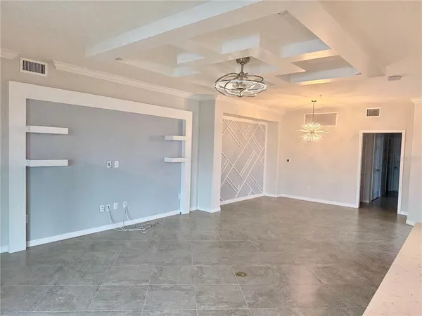 a large kitchen with stainless steel appliances kitchen island granite countertop a stove a sink a microwave and cabinets