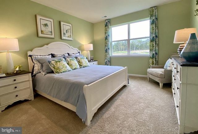 a bathroom with a double vanity sink a mirror and next to a window
