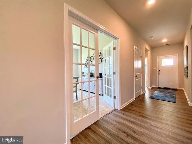 a kitchen that has a lot of cabinets a sink and appliances in it