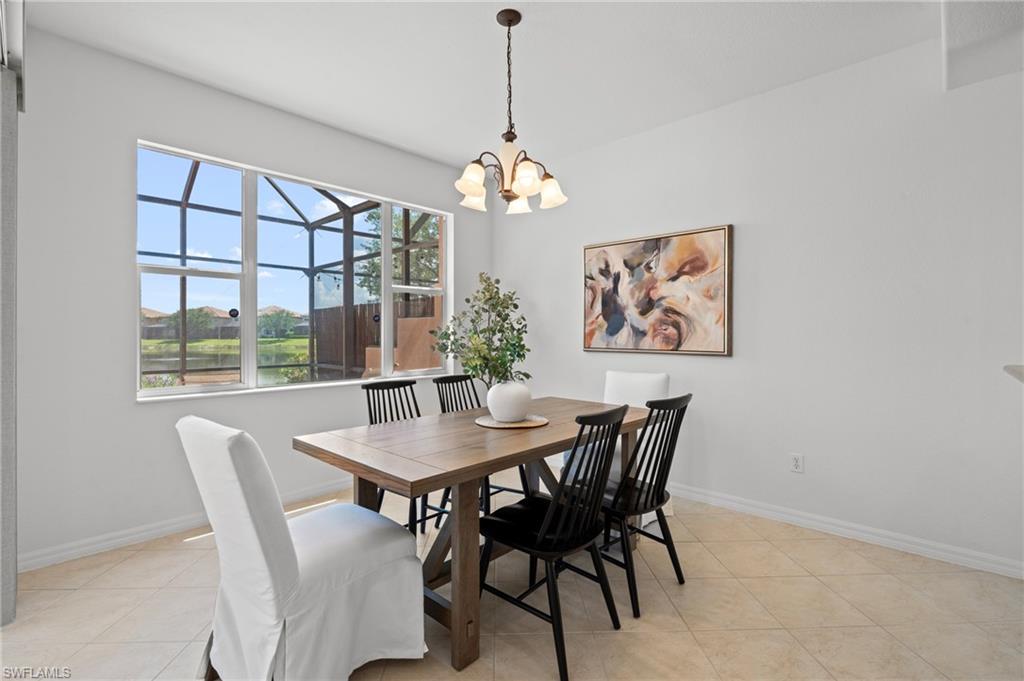 20467 Larino Loop Estero, FL 33928 - Photo 14 of 45 a dining room with furniture a window and a chandelier