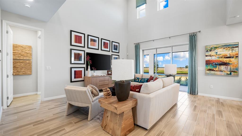 13333 Stable Place Parrish, FL 34219 - Photo 11 of 33 a living room with furniture and a flat screen tv