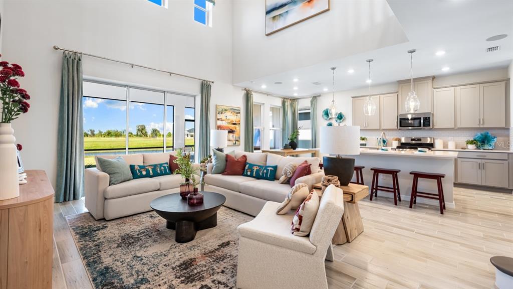 13333 Stable Place Parrish, FL 34219 - Photo 12 of 33 a living room with furniture dining area and a large window