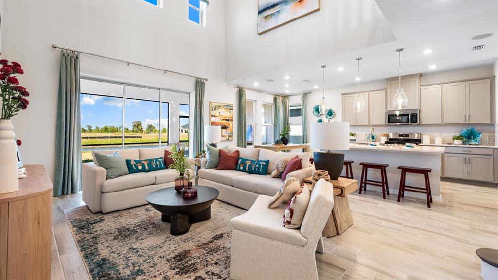 13333 Stable Place Parrish, FL 34219 - Photo 13 of 33 a living room with furniture dining area and a large window