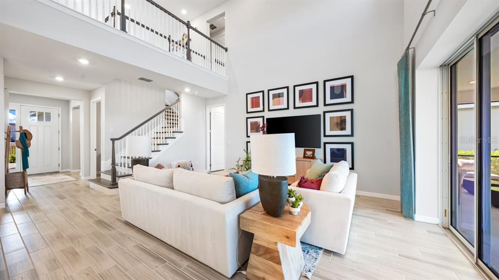 13333 Stable Place Parrish, FL 34219 - Photo 15 of 33 a living room with furniture a lamp and wooden floor