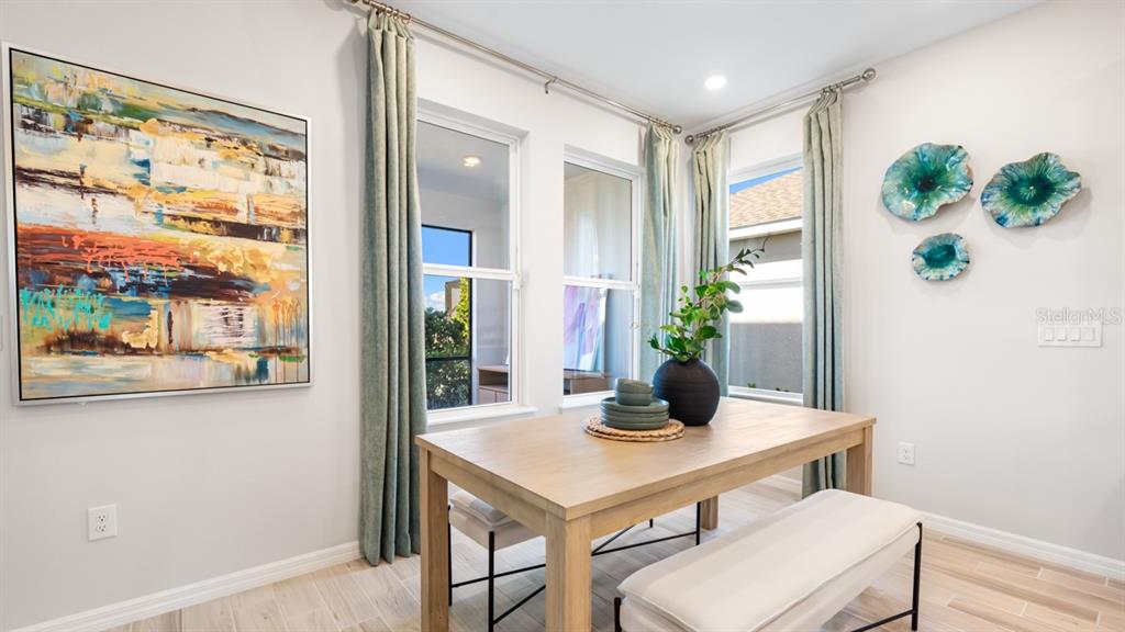 13333 Stable Place Parrish, FL 34219 - Photo 23 of 33 a dining room with furniture and wooden floor