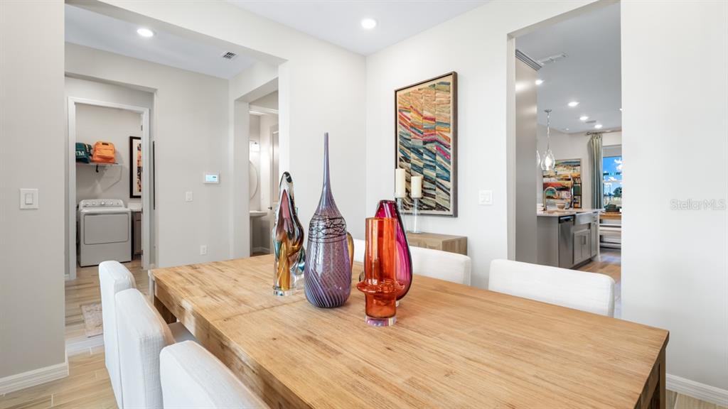 13333 Stable Place Parrish, FL 34219 - Photo 8 of 33 a view of a kitchen with kitchen island a refrigerator and microwave
