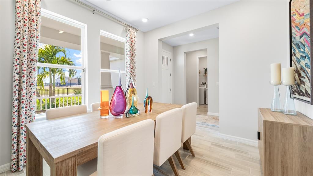 13333 Stable Place Parrish, FL 34219 - Photo 9 of 33 a dining room with furniture and wooden floor