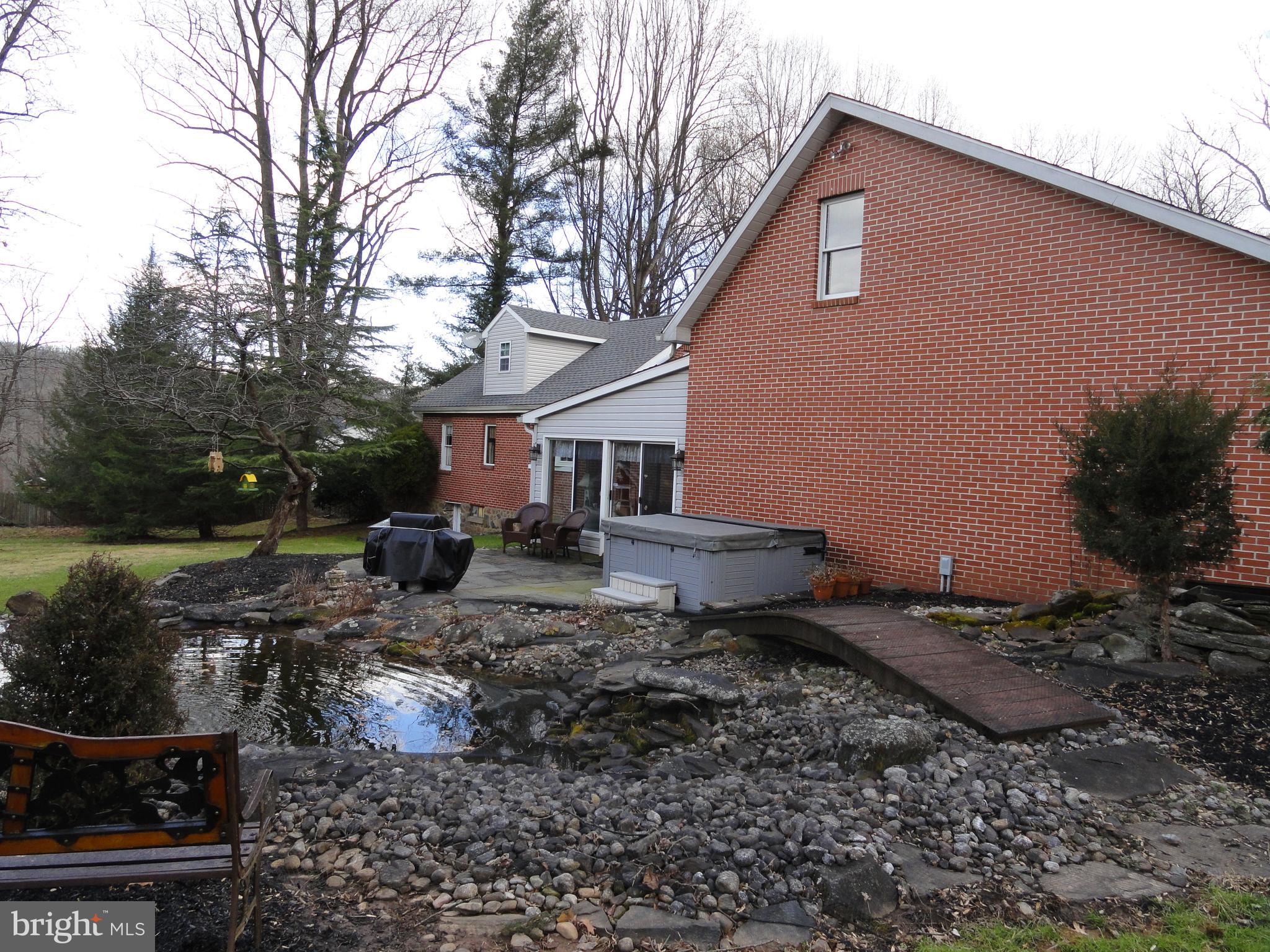 793 Henning Road Perkiomenville, PA 18074 - Photo 54 of 67 Koi ponds and bridge behind house and garage