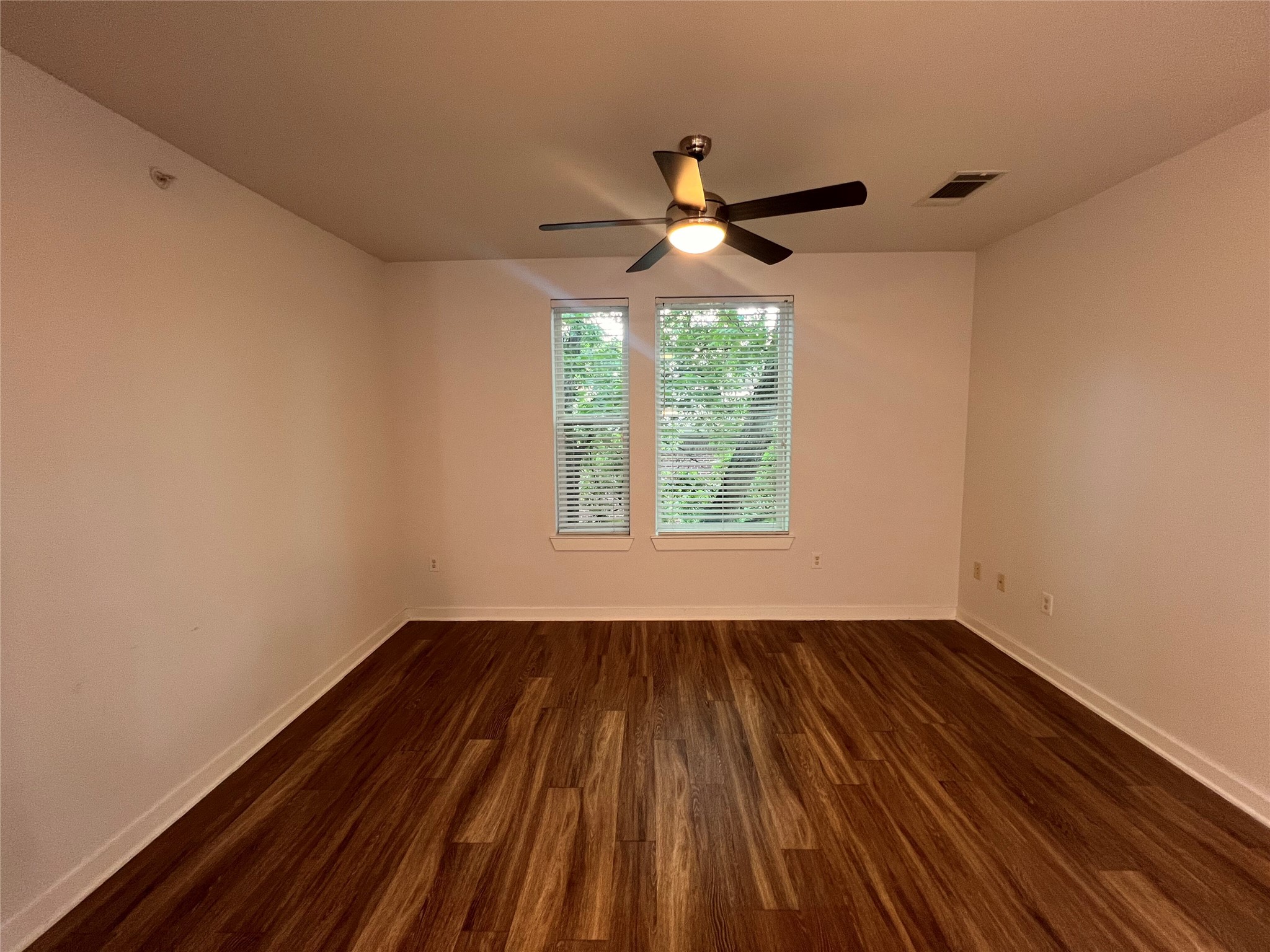 1900 Barton Springs Road, Unit 4041 Austin, TX 78704 - Photo 14 of 35 a view of empty room with wooden floor and fan