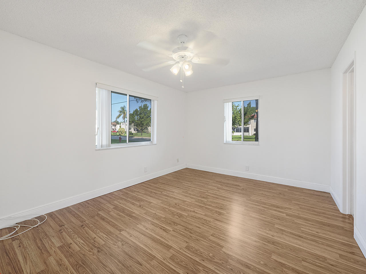 6723 Moonlit Drive Delray Beach, FL 33446 - Photo 11 of 16 a view of empty room with wooden floor and fan