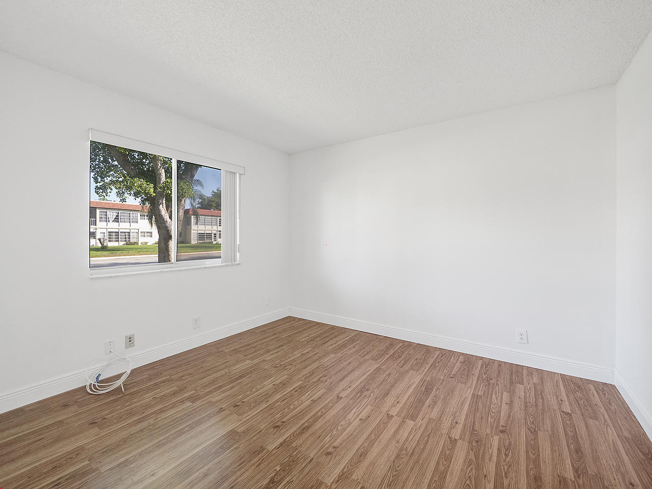 6723 Moonlit Drive Delray Beach, FL 33446 - Photo 14 of 16 a view of a room with wooden floor and window