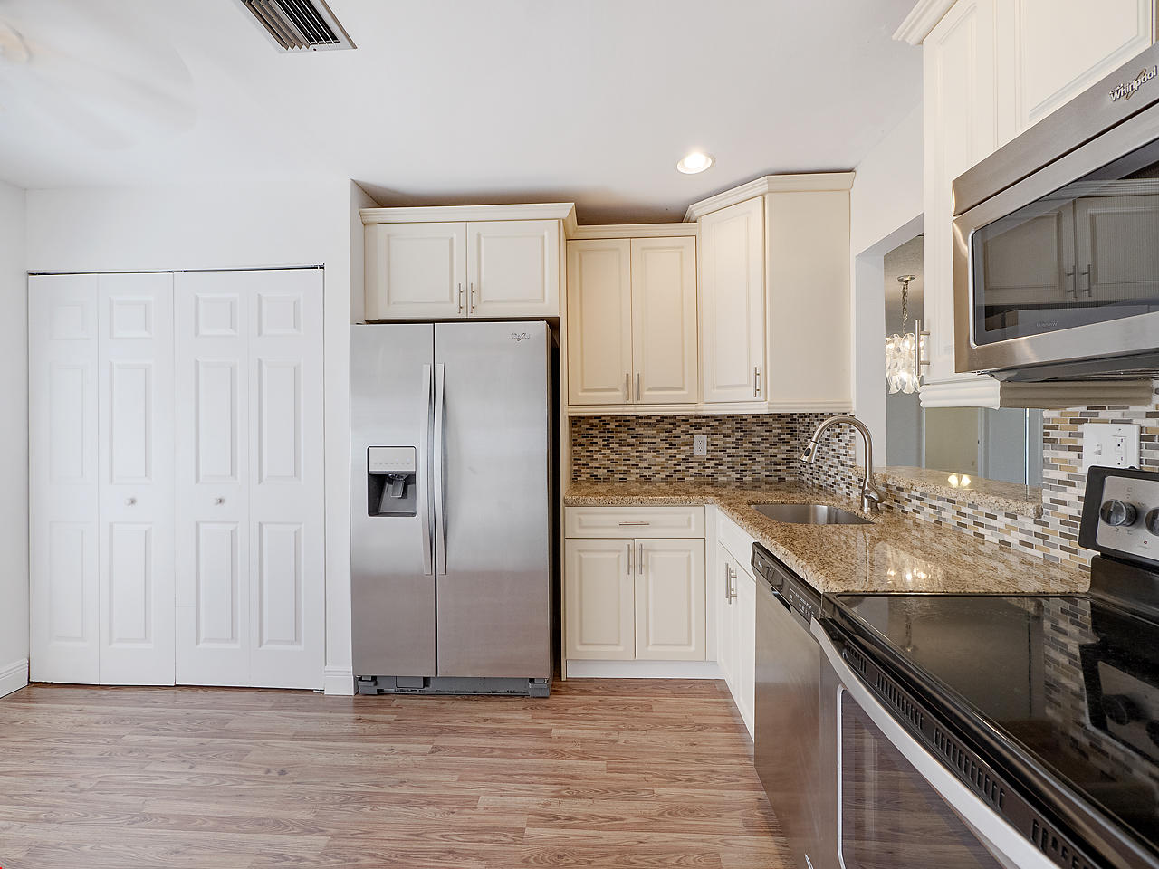 6723 Moonlit Drive Delray Beach, FL 33446 - Photo 4 of 16 a kitchen with stainless steel appliances granite countertop a refrigerator sink and microwave