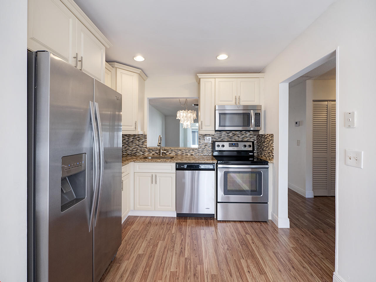 6723 Moonlit Drive Delray Beach, FL 33446 - Photo 5 of 16 a kitchen with a refrigerator and a stove top oven