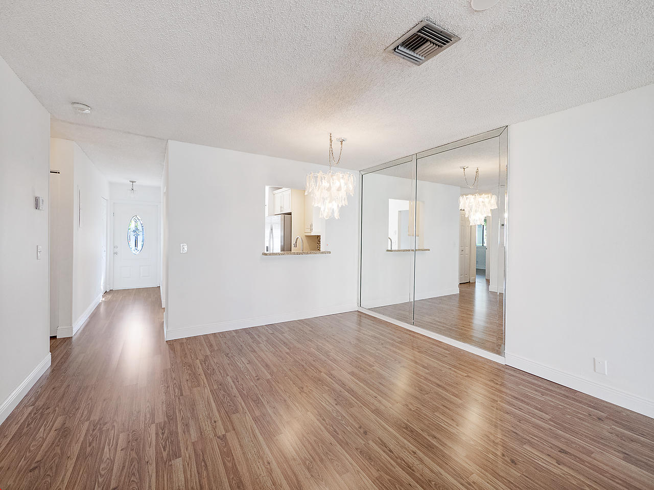 6723 Moonlit Drive Delray Beach, FL 33446 - Photo 7 of 16 a view of an empty room with wooden floor and a window