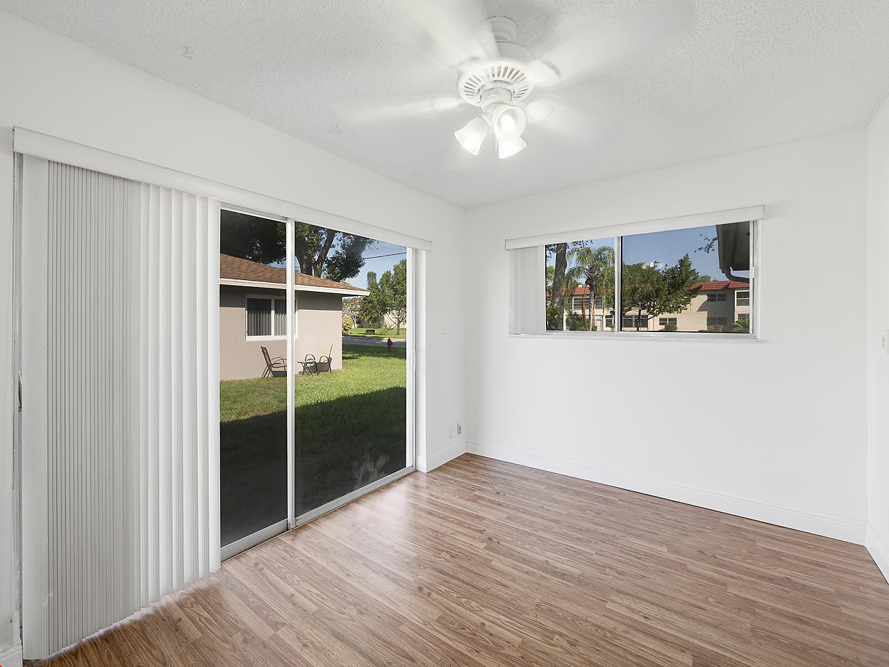 6723 Moonlit Drive Delray Beach, FL 33446 - Photo 8 of 16 a view of empty room with wooden floor and fan