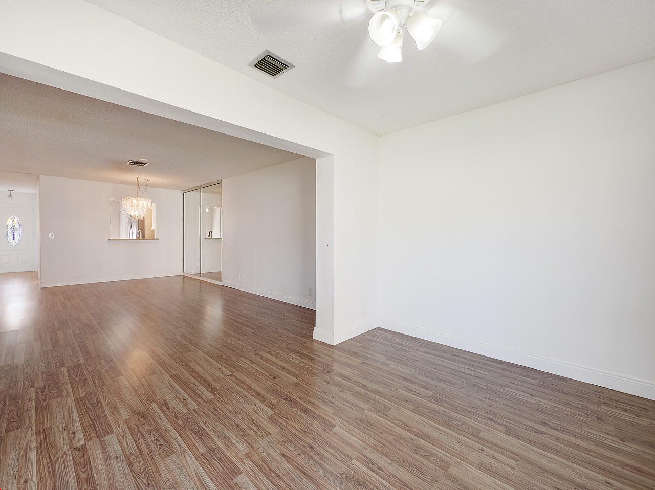 6723 Moonlit Drive Delray Beach, FL 33446 - Photo 10 of 16 a view of an empty room with wooden floor and a window