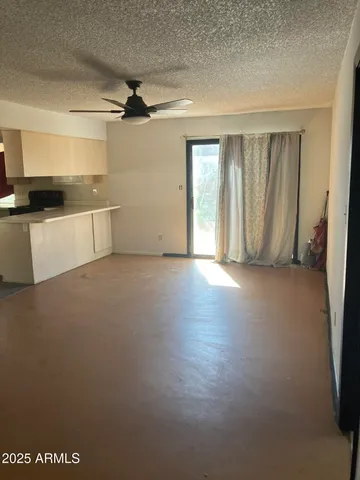 a utility room with stainless steel appliances a white wooden cabinets