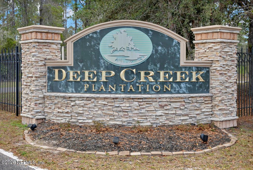 15364 Bullock Bluff Road Bryceville, FL 32009 - Photo 1 of 24 a view of outdoor space with signage and flags