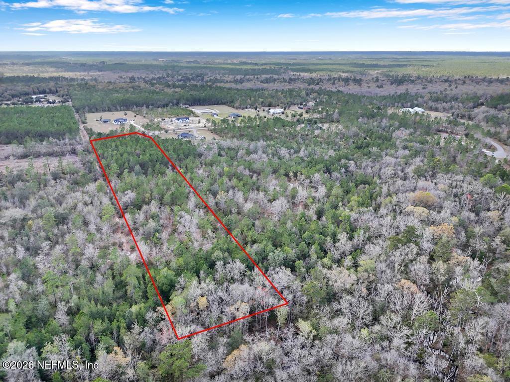 15364 Bullock Bluff Road Bryceville, FL 32009 - Photo 18 of 24 an aerial view of residential houses with outdoor space and trees