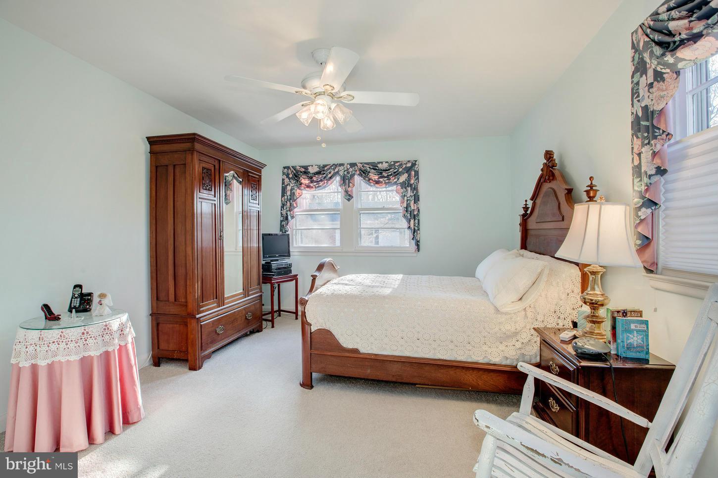 8632 Geren Road, Unit 158 Silver Spring, MD 20901 - Photo 13 of 20 a bedroom with a bed and a chandelier