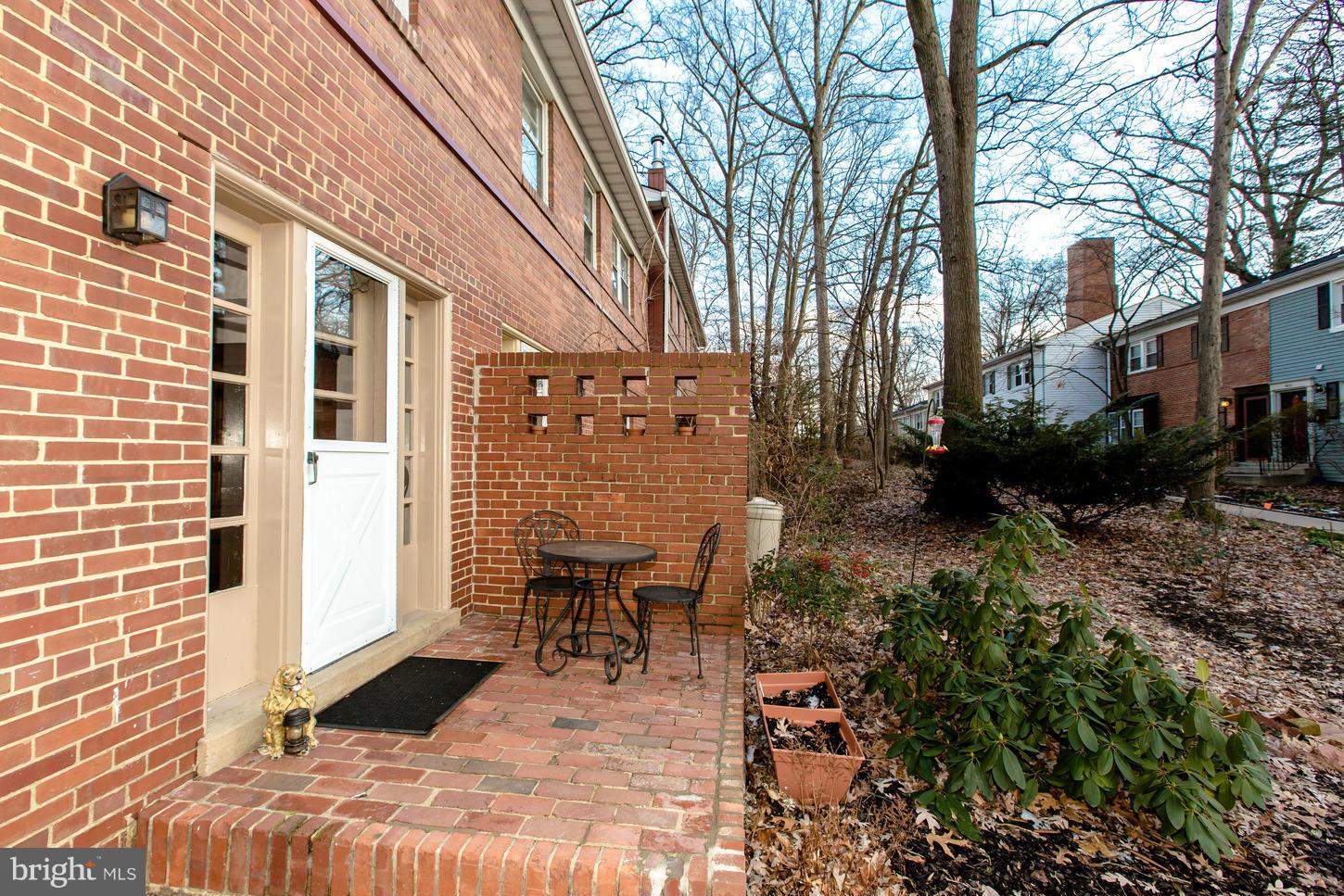 8632 Geren Road, Unit 158 Silver Spring, MD 20901 - Photo 17 of 20 a view of a patio with table and chairs and potted plants