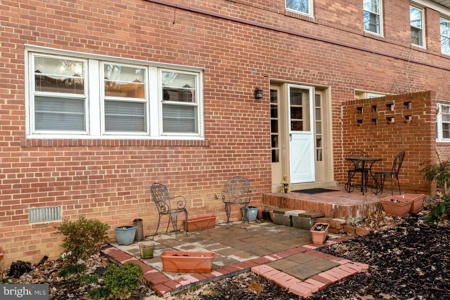8632 Geren Road, Unit 158 Silver Spring, MD 20901 - Photo 18 of 20 a view of a brick house with a yard