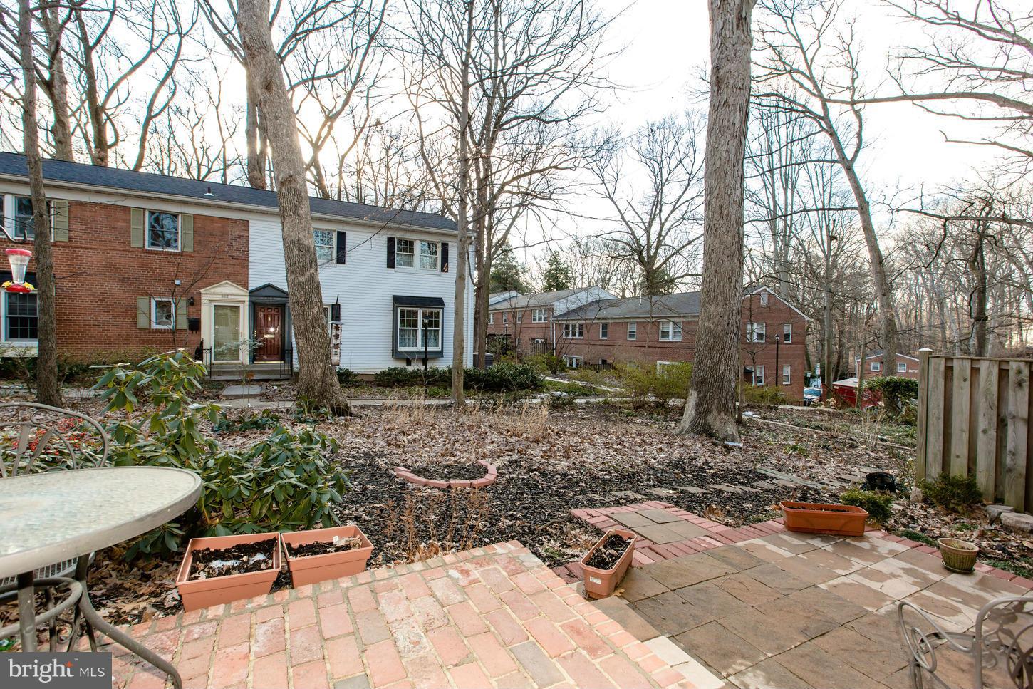 8632 Geren Road, Unit 158 Silver Spring, MD 20901 - Photo 19 of 20 a view of a backyard with table and chairs and potted plants
