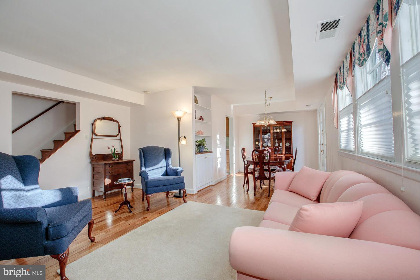 8632 Geren Road, Unit 158 Silver Spring, MD 20901 - Photo 3 of 20 a living room with furniture and wooden floor