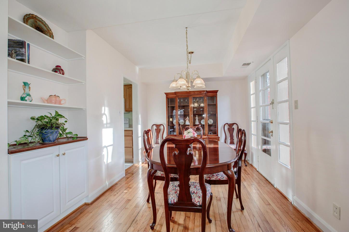 8632 Geren Road, Unit 158 Silver Spring, MD 20901 - Photo 5 of 20 a view of a dining room with furniture window and wooden floor