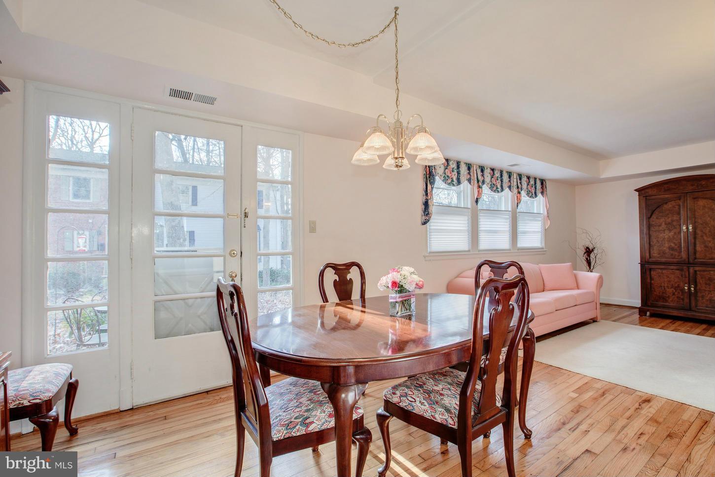 8632 Geren Road, Unit 158 Silver Spring, MD 20901 - Photo 6 of 20 a view of a dining room with furniture window and wooden floor