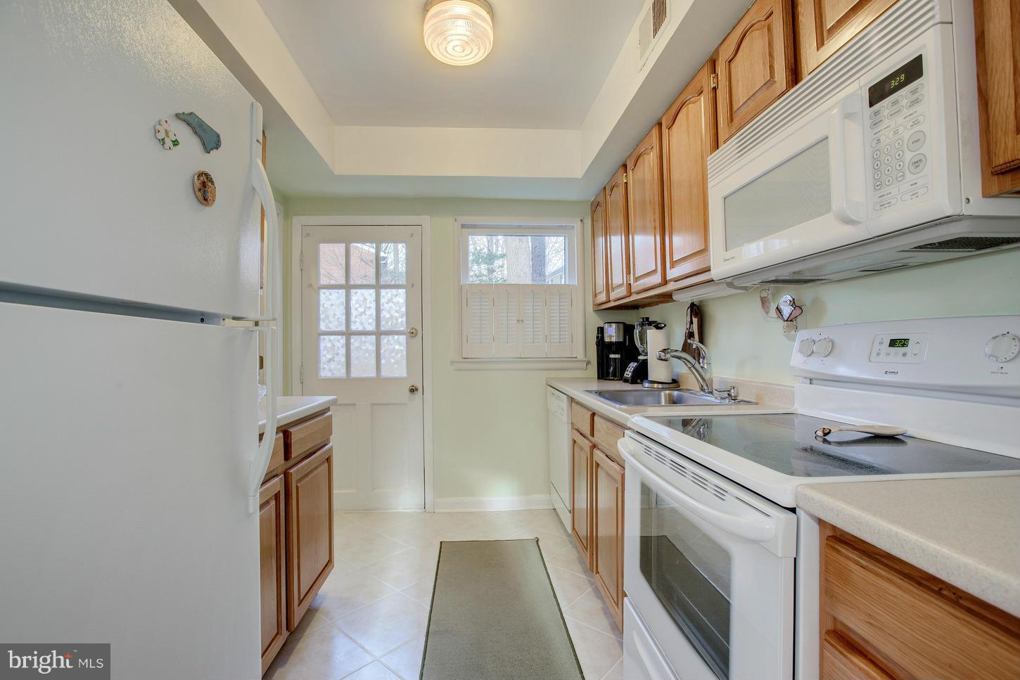 8632 Geren Road, Unit 158 Silver Spring, MD 20901 - Photo 7 of 20 a kitchen with a sink cabinets and stainless steel appliances