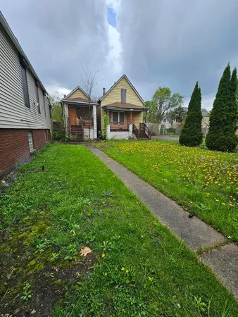 a front view of a house with a yard and porch