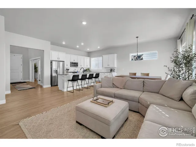 a living room with furniture and kitchen view