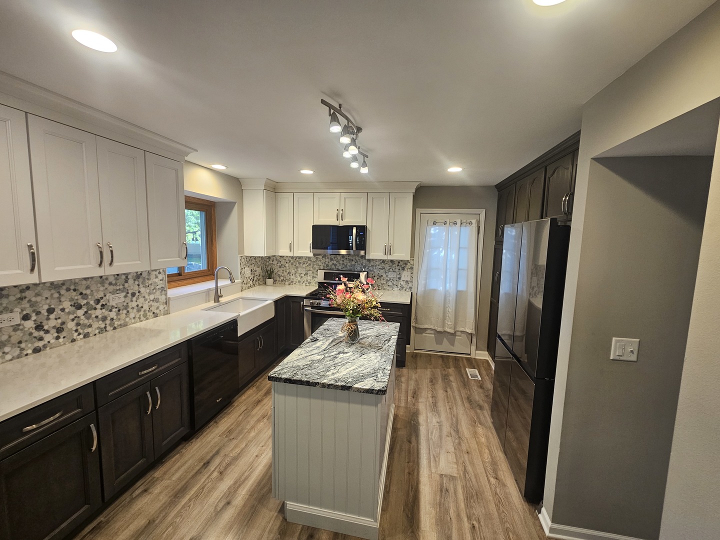 1681 Boulder Ridge Drive Bolingbrook, IL 60490 - Photo 6 of 17 a kitchen with granite countertop stainless steel appliances a refrigerator a sink a stove top oven and cabinets