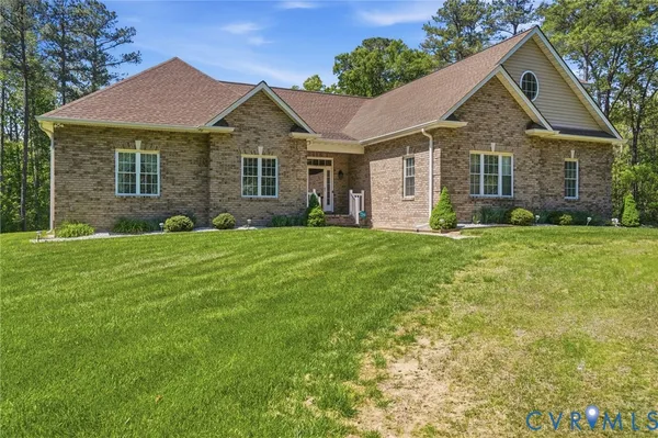 a front view of a house with a garden and yard