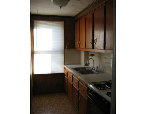 43 William Street Fall River, MA 02721 - Photo 5 of 7 a kitchen with a sink and a stove