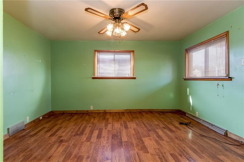 771 Beaver Street Rochester, PA 15074 - Photo 3 of 16 Another view of the living room, newer flooring, blinds and fan included.
