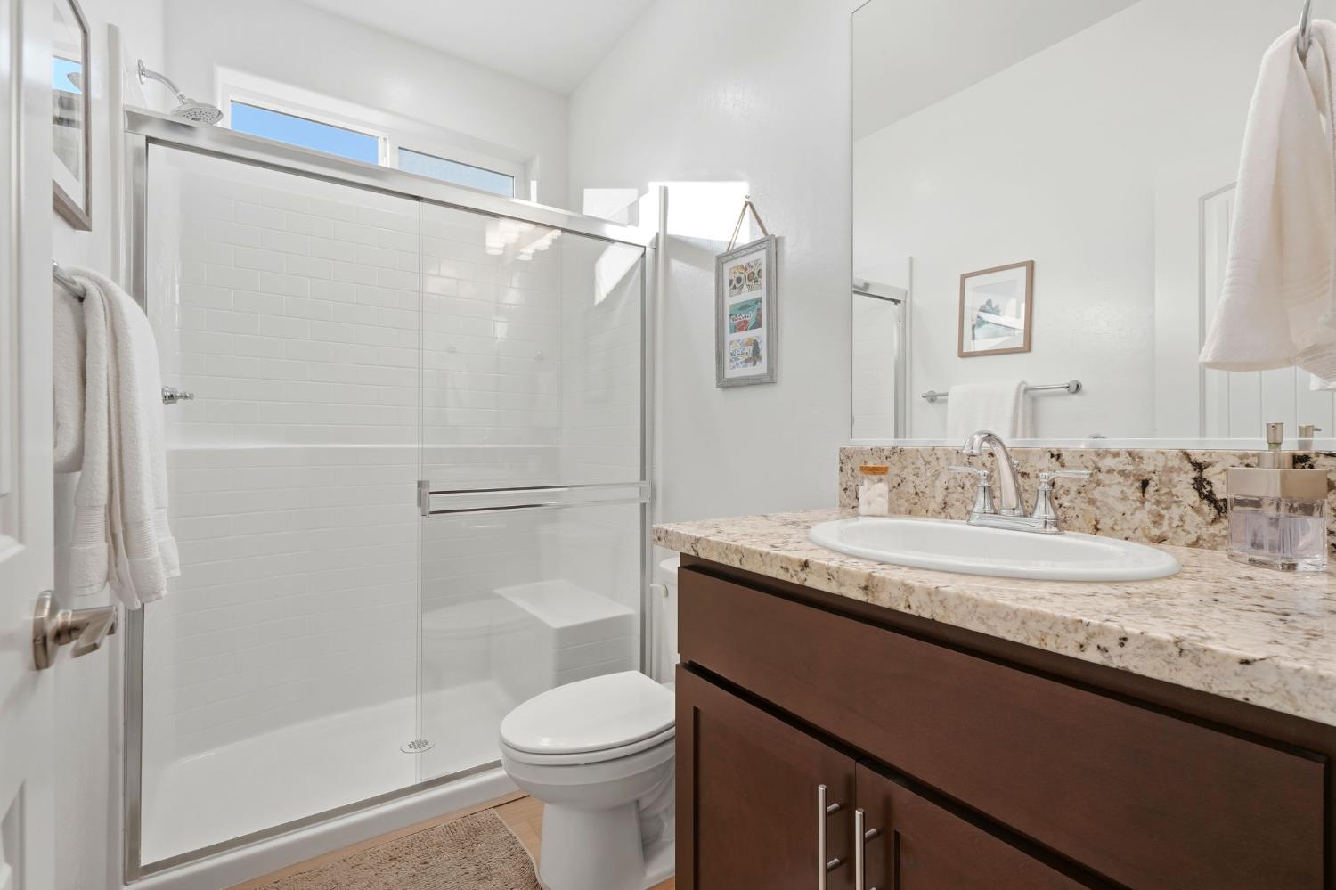 2566 Muscat Court Hanford, CA 93230 - Photo 12 of 55 a bathroom with a granite countertop sink toilet and shower