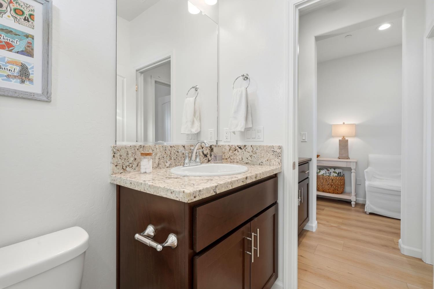 2566 Muscat Court Hanford, CA 93230 - Photo 13 of 55 a bathroom with a granite countertop sink a toilet and a mirror