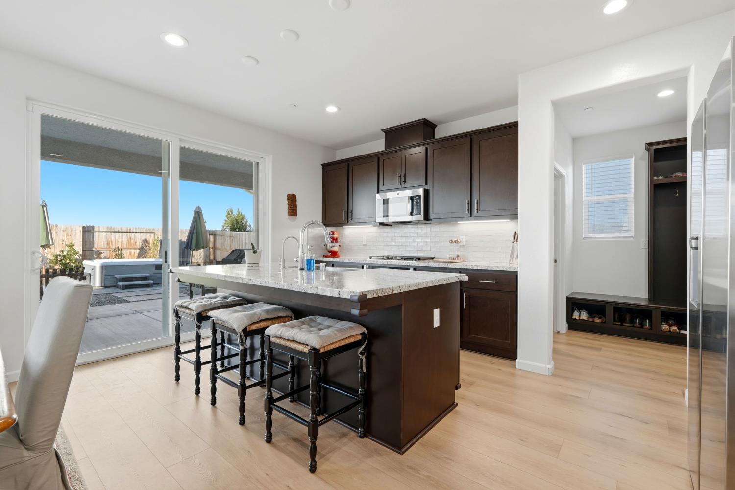 2566 Muscat Court Hanford, CA 93230 - Photo 27 of 55 a kitchen with stainless steel appliances granite countertop a stove a sink a refrigerator and a dining table