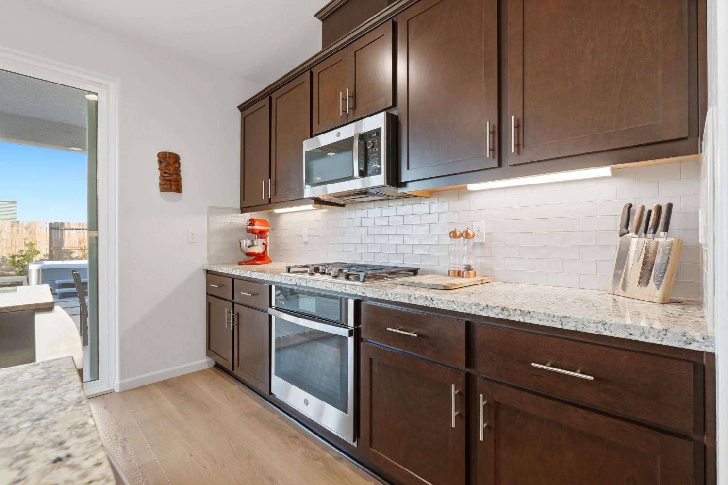 2566 Muscat Court Hanford, CA 93230 - Photo 29 of 55 a kitchen with stainless steel appliances granite countertop a sink stove and microwave