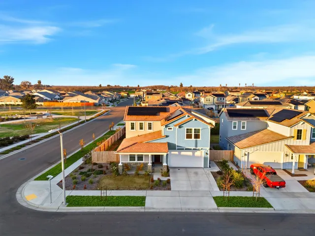 an aerial view of residential houses with outdoor space