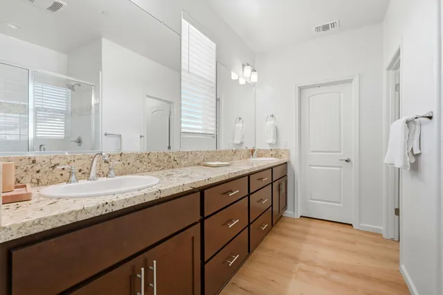 a bathroom with a granite countertop sink and a mirror