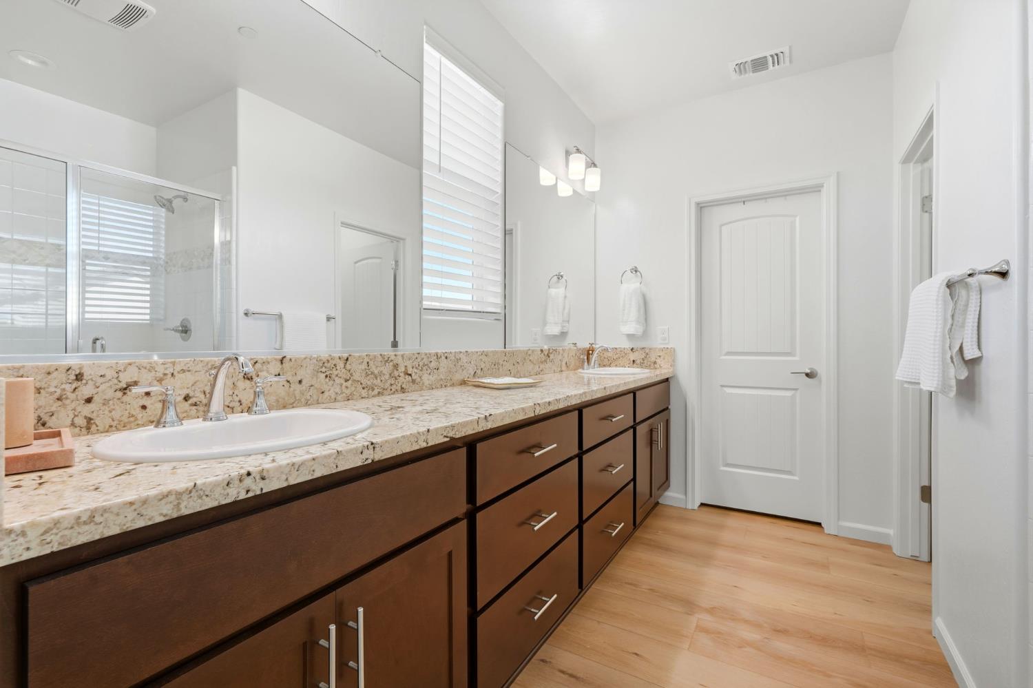 2566 Muscat Court Hanford, CA 93230 - Photo 42 of 55 a bathroom with a granite countertop sink and a mirror