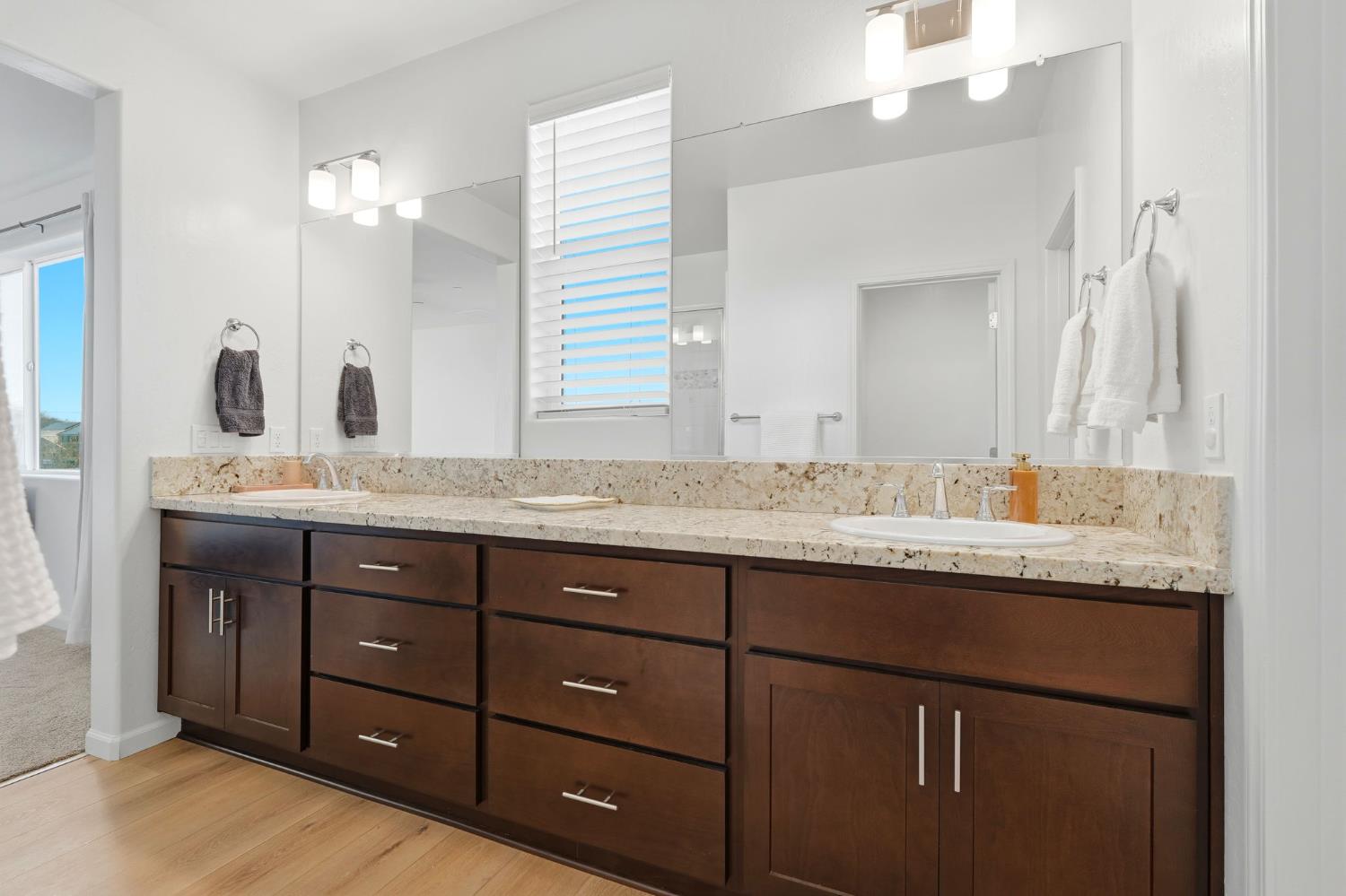 2566 Muscat Court Hanford, CA 93230 - Photo 43 of 55 a bathroom with a granite countertop double vanity sink and a mirror