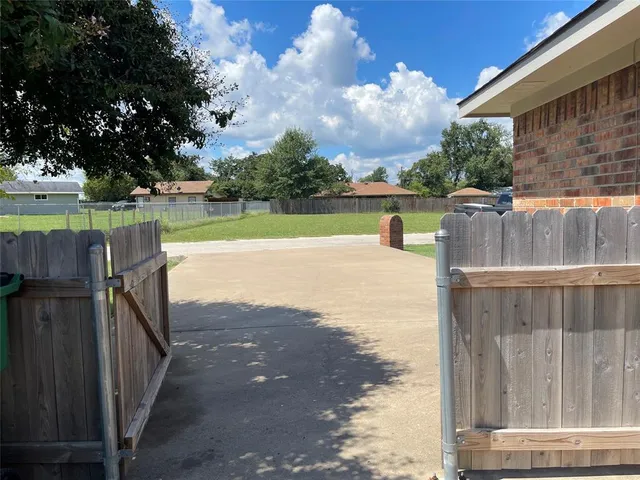 a front view of a house with wooden fence